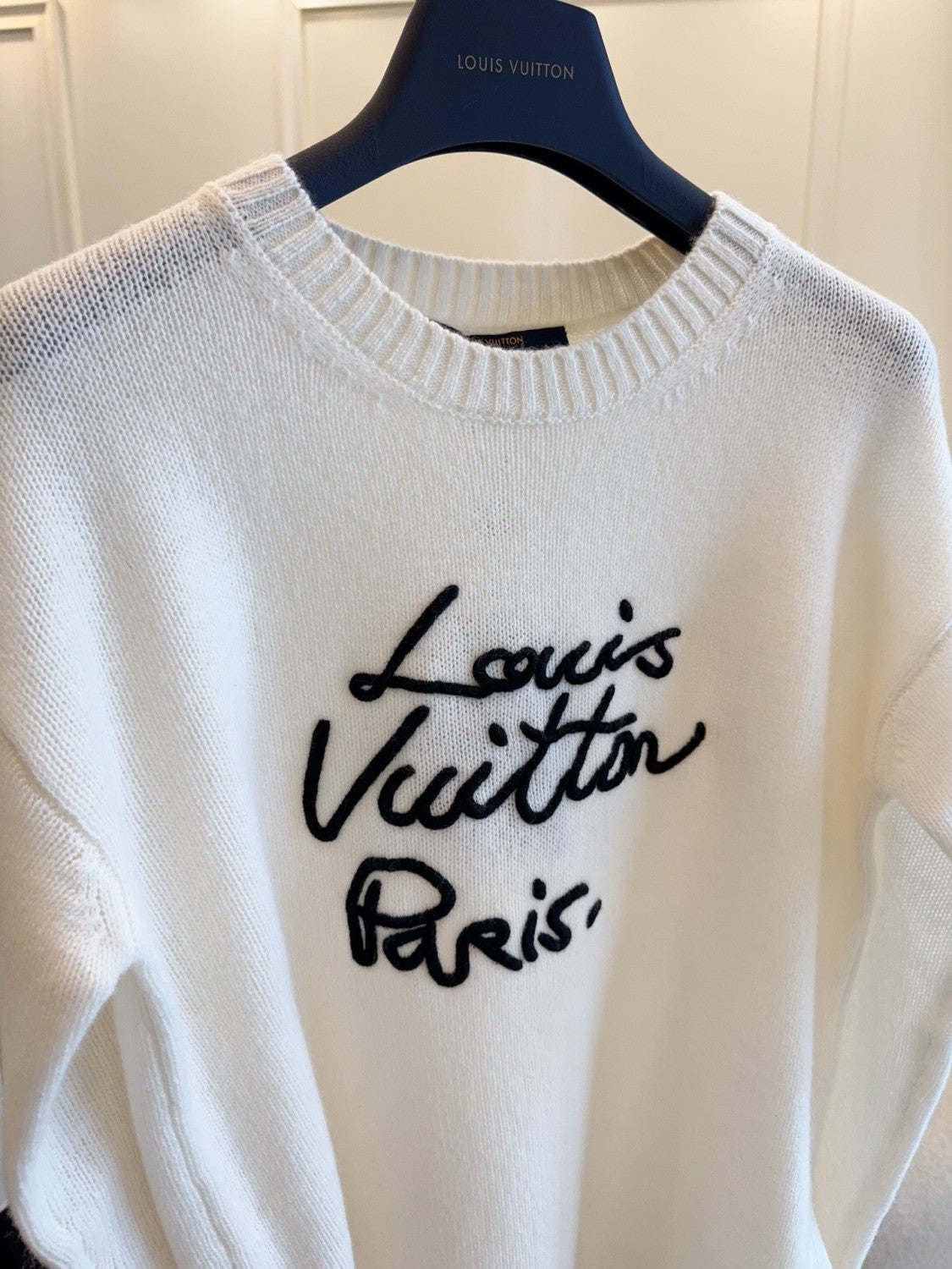 FallWinter 2025 Women's White Sweater. soft and skin-friendly. round neck with black logo embroidery. a casual and comfortable women's sweater. #83197A